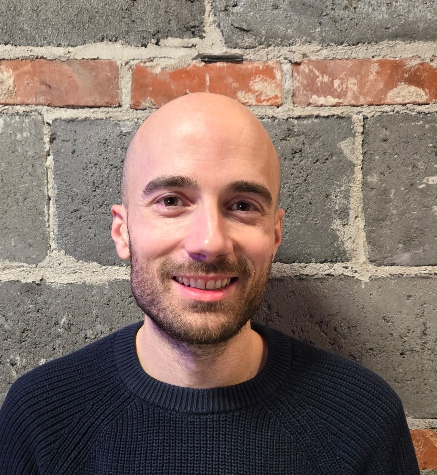 Headshot of Lethbridge sim racing coach in front of brick wall